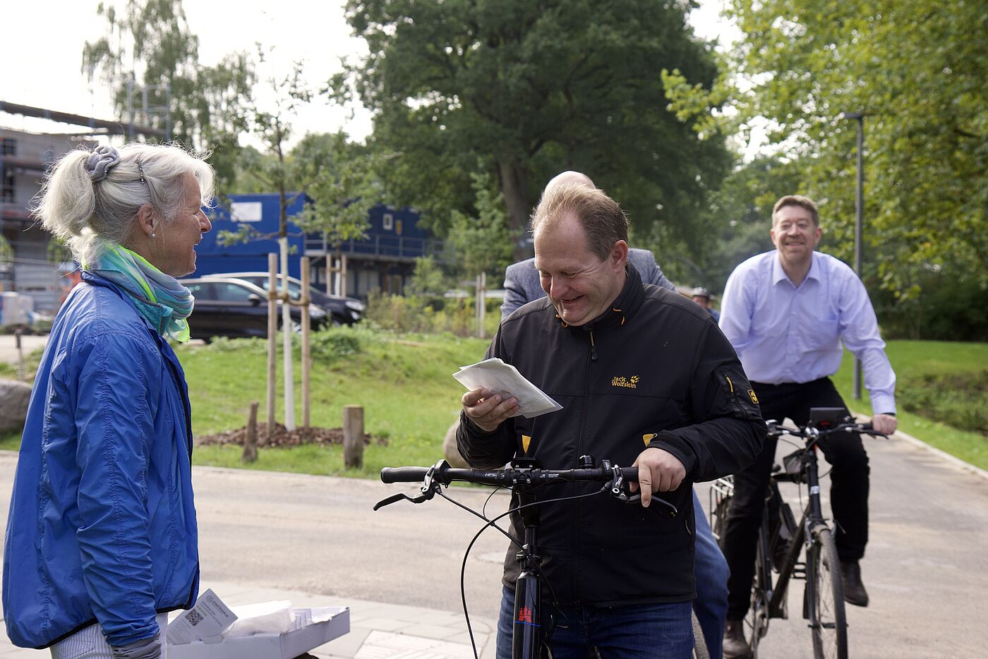Jens Kerstan erhält Tüte mit Franzbrötchen fürs Radfahren