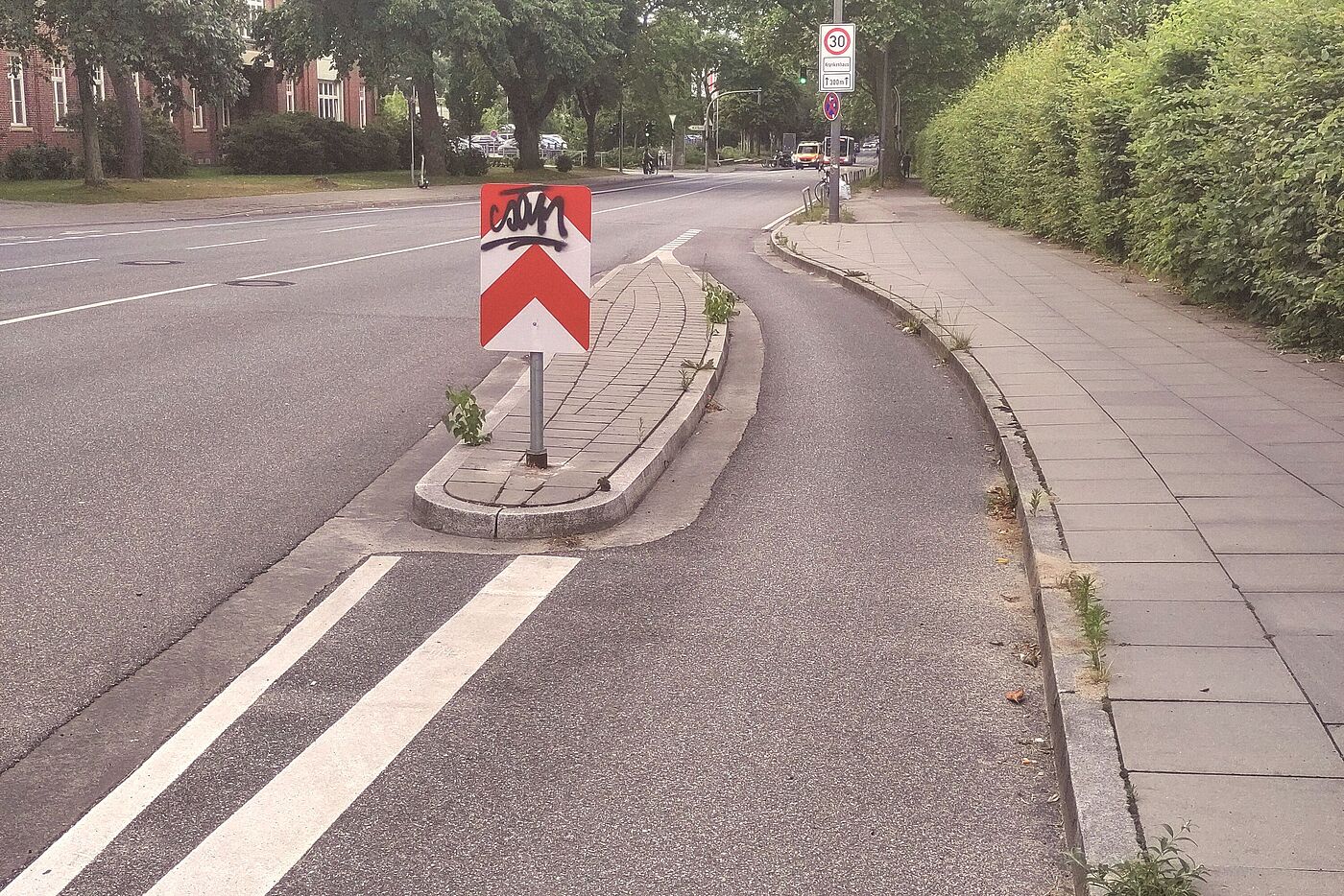 Zwischen Radfahrstreifen und Fahrstreifen liegt eine ca. 80 cm breite Verkehrsinsel